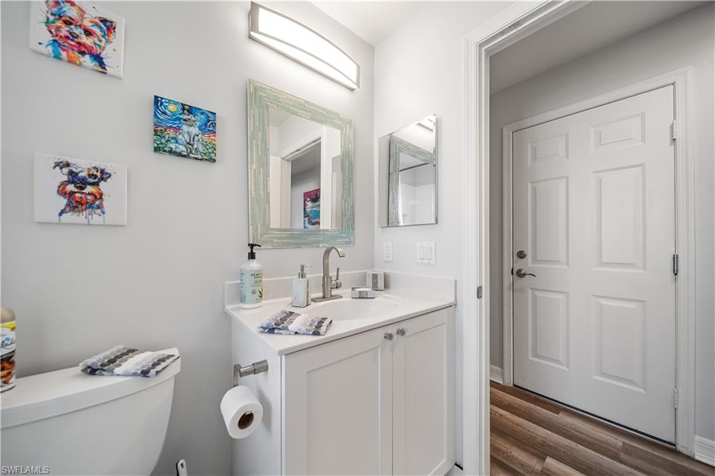 1638 Triangle Palm Terrace Naples, FL 34119 - Photo 14 of 21 Bathroom with vanity and wood finished floors