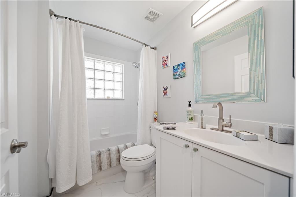 1638 Triangle Palm Terrace Naples, FL 34119 - Photo 15 of 21 Bathroom with vanity, shower / bathtub combination with curtain, and marble finish flooring