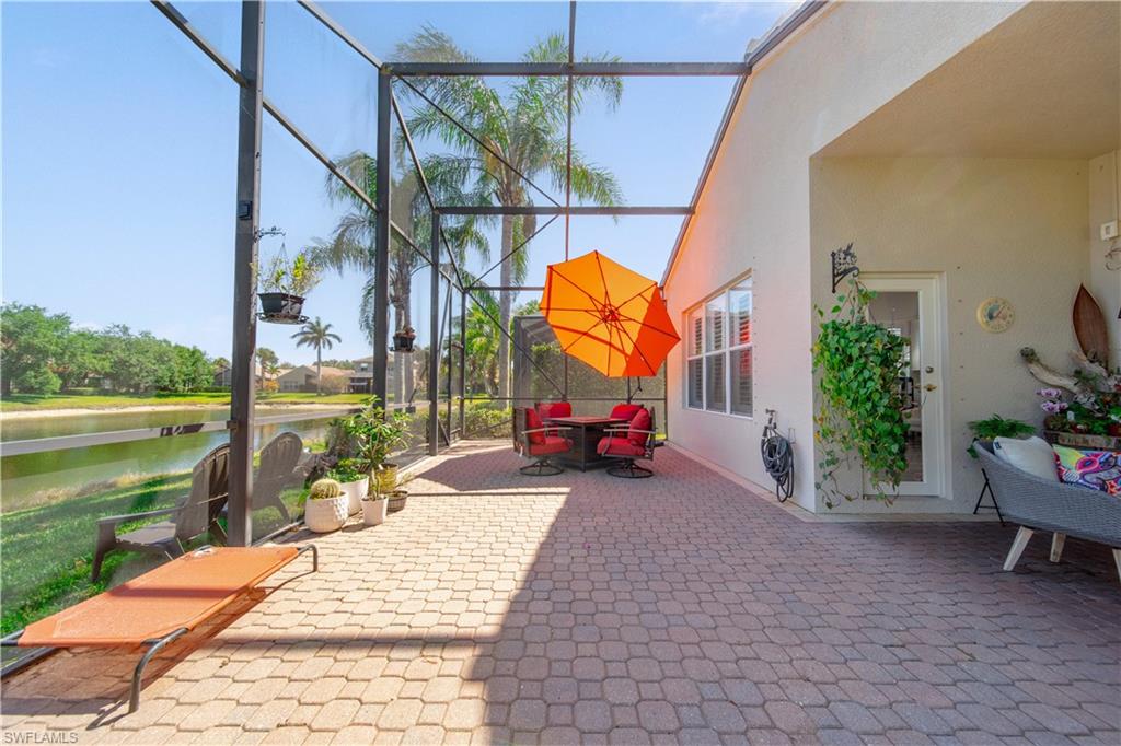 1638 Triangle Palm Terrace Naples, FL 34119 - Photo 20 of 21 View of patio featuring glass enclosure and a water view