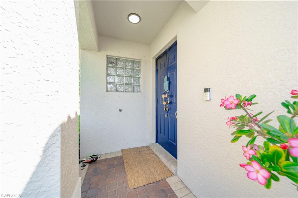 1638 Triangle Palm Terrace Naples, FL 34119 - Photo 2 of 21 Doorway to property featuring stucco siding