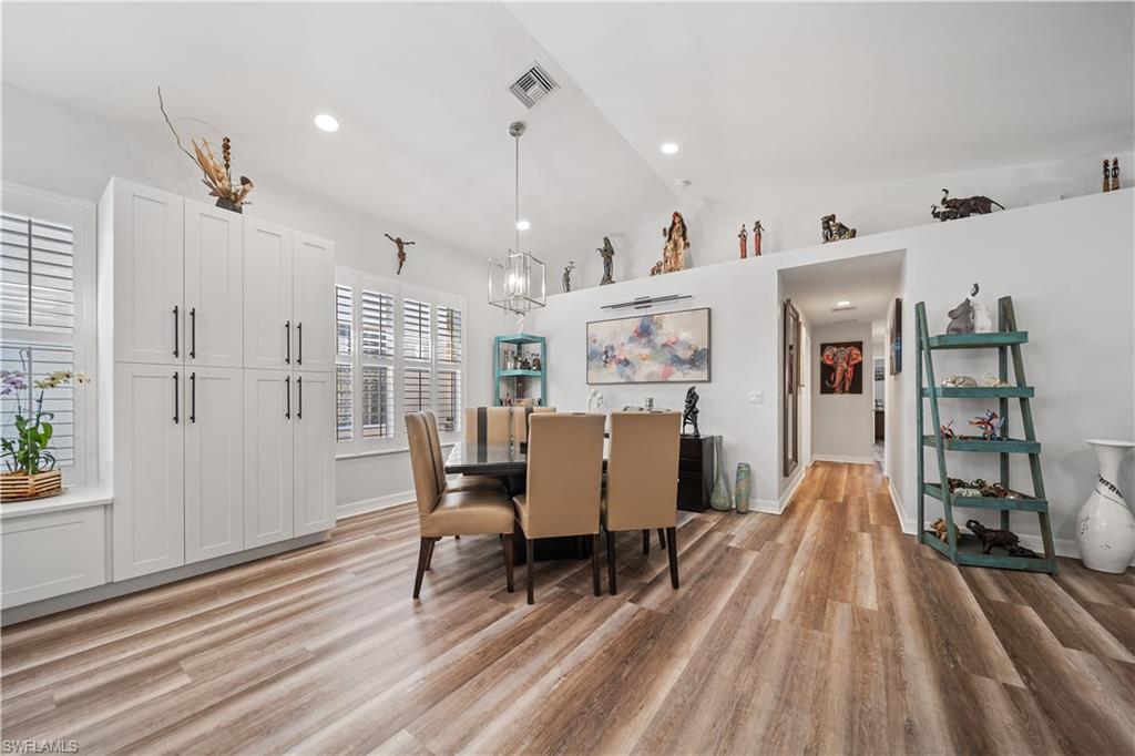 1638 Triangle Palm Terrace Naples, FL 34119 - Photo 7 of 21 Dining area with lofted ceiling, a chandelier, light wood finished floors, and recessed lighting