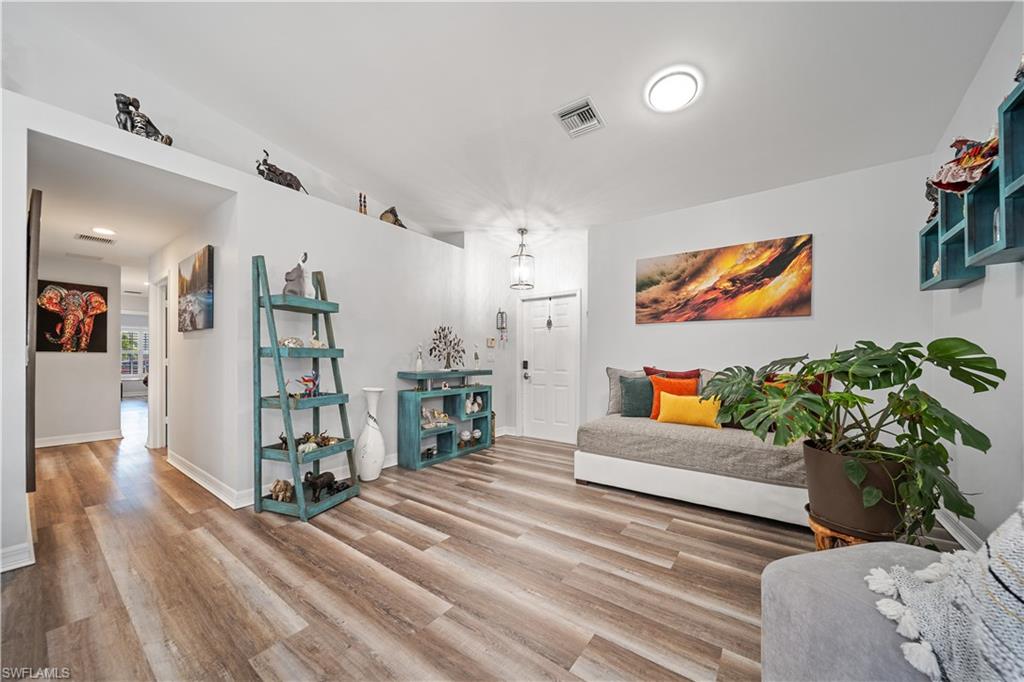 1638 Triangle Palm Terrace Naples, FL 34119 - Photo 9 of 21 Living area with wood finished floors and baseboards