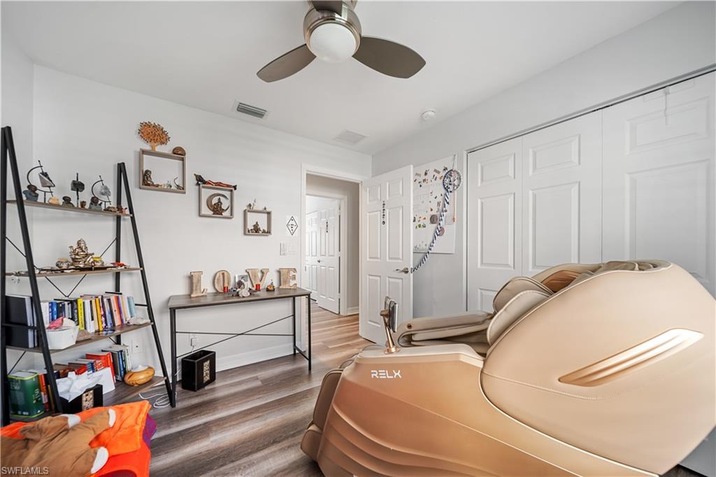 1638 Triangle Palm Terrace Naples, FL 34119 - Photo 10 of 21 Bedroom with wood finished floors, a closet, and a ceiling fan