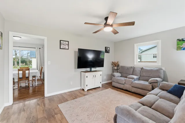 a picture of a room with furniture and a refrigerator