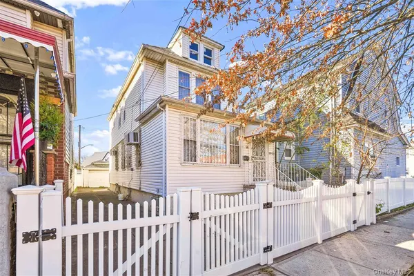 a view of a house with wooden fence