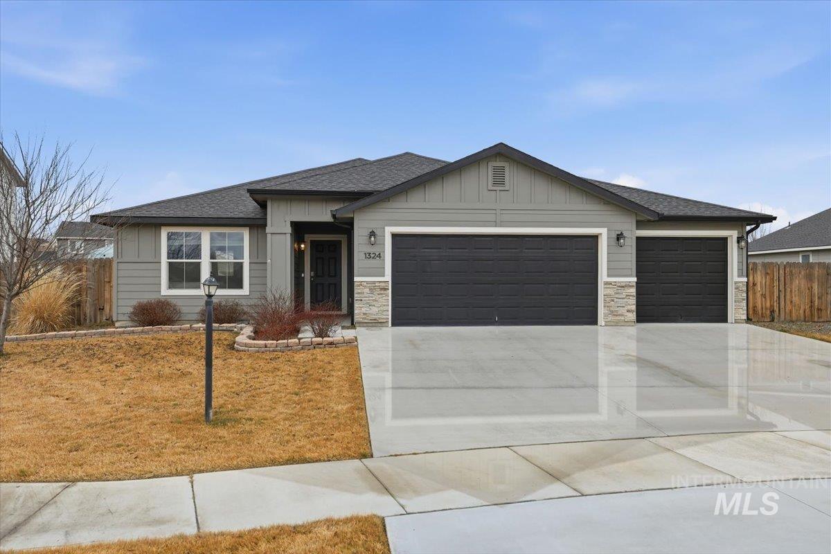 1324 Gold Street Middleton, ID 83644 - Photo 1 of 1 View of front of property with stone siding, board and batten siding, roof with shingles, and an attached garage