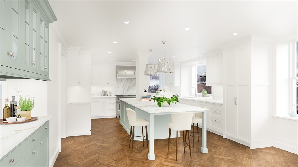 34.5 Beacon Street, Unit PH Boston, MA 02116 - Photo 3 of 11 a kitchen with stainless steel appliances kitchen island granite countertop a table chairs sink and cabinets