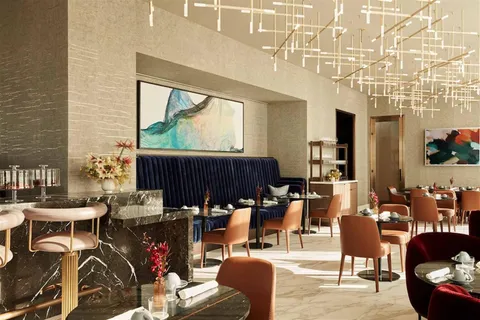 a living room with lots of furniture and a large window