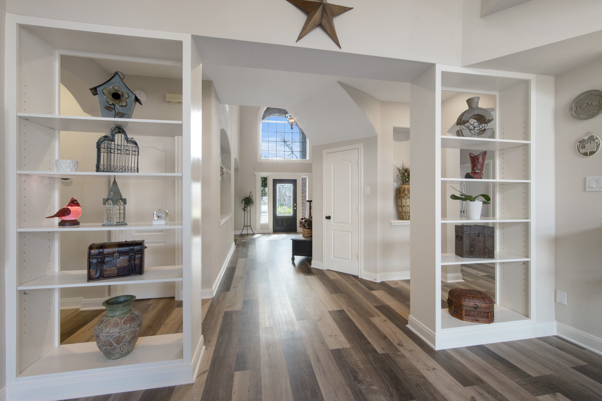9510 Ashdown Forest Drive Spring, TX 77379 - Photo 4 of 50 Custom built-in shelving provides the perfect space to display décor, art, or family treasures while adding architectural charm to the entry area.