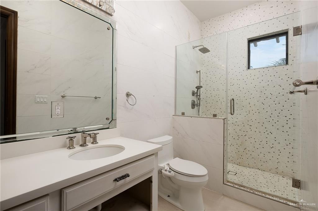 22111 Uresti Road Edinburg, TX 78542 - Photo 23 of 38 White vanity with an undermount sink and brushed nickel faucet