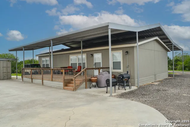 a view of a patio with table and chairs