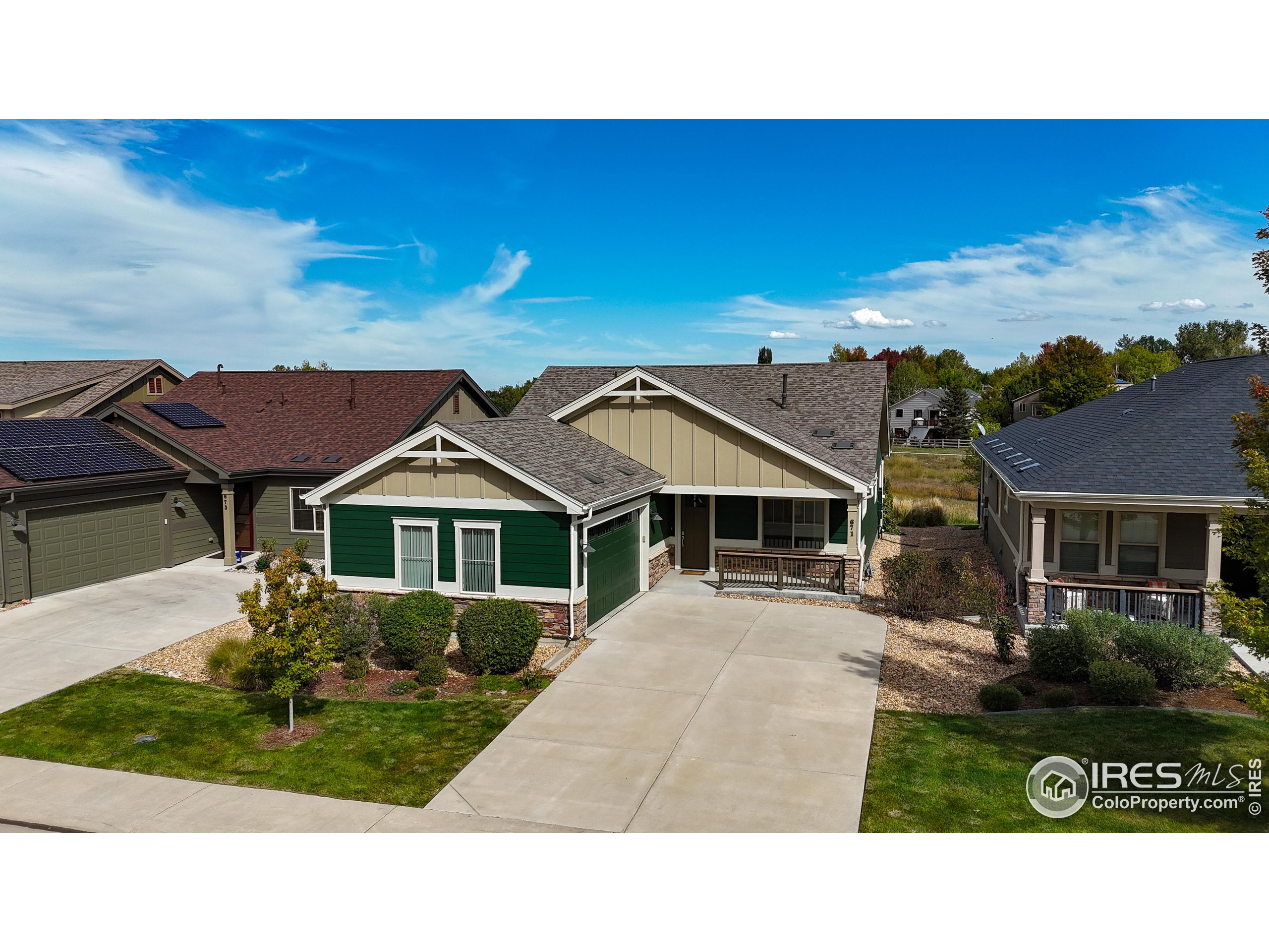 a black and white house with a yard