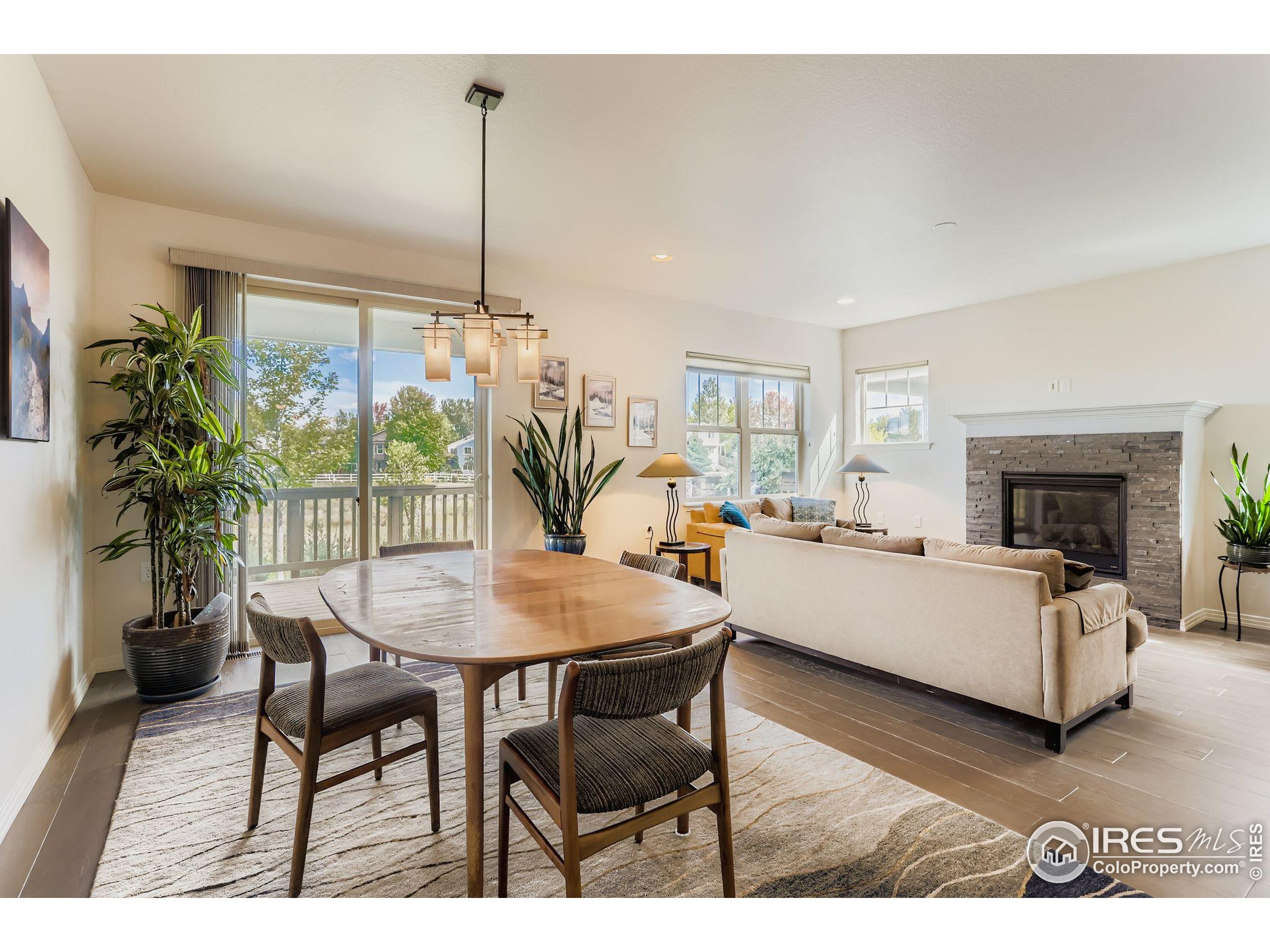 671 Brennan Circle Erie, CO 80516 - Photo 12 of 26 a living room with furniture and a floor to ceiling window