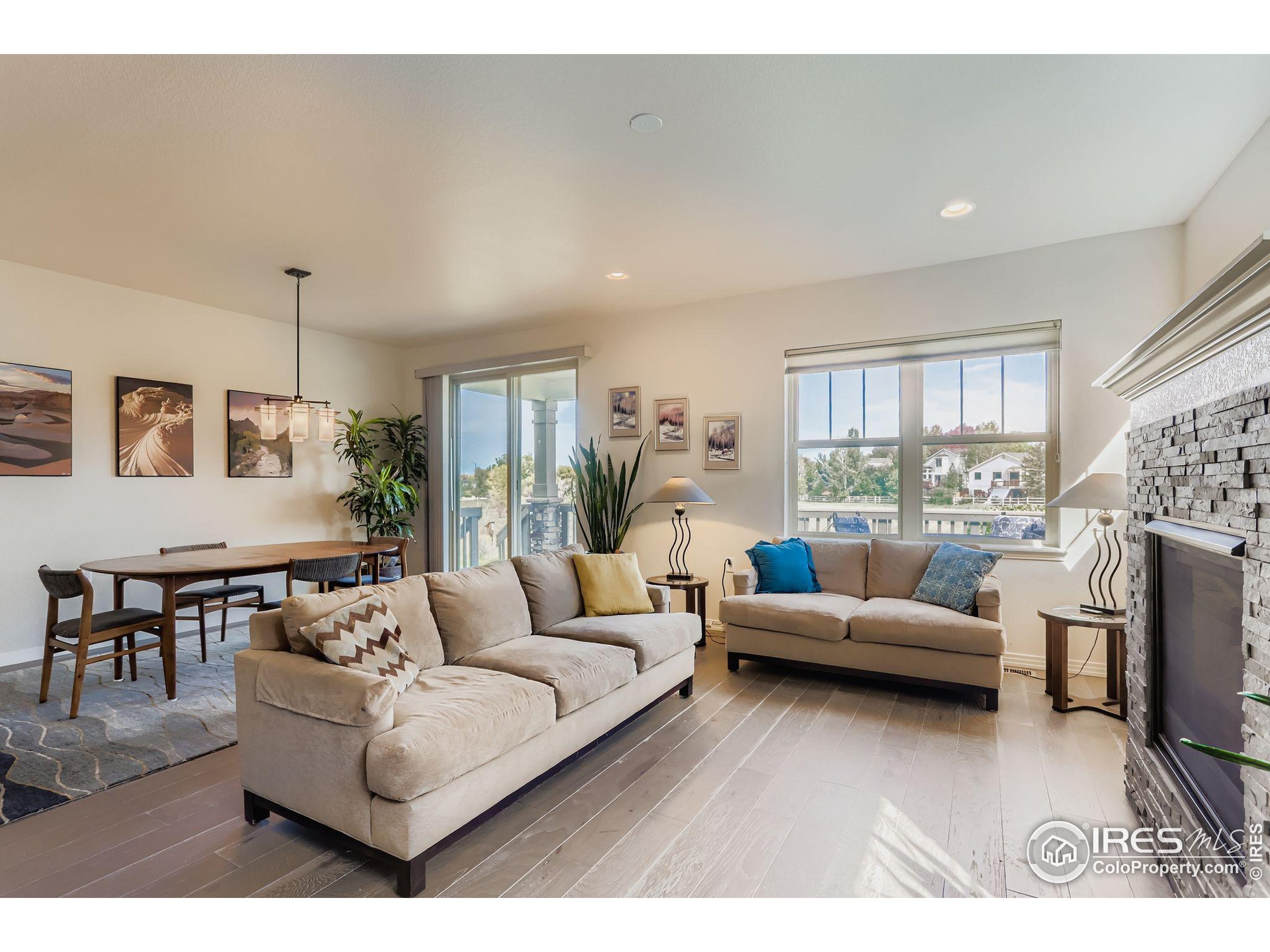 671 Brennan Circle Erie, CO 80516 - Photo 5 of 26 a living room with furniture a fireplace and a flat screen tv