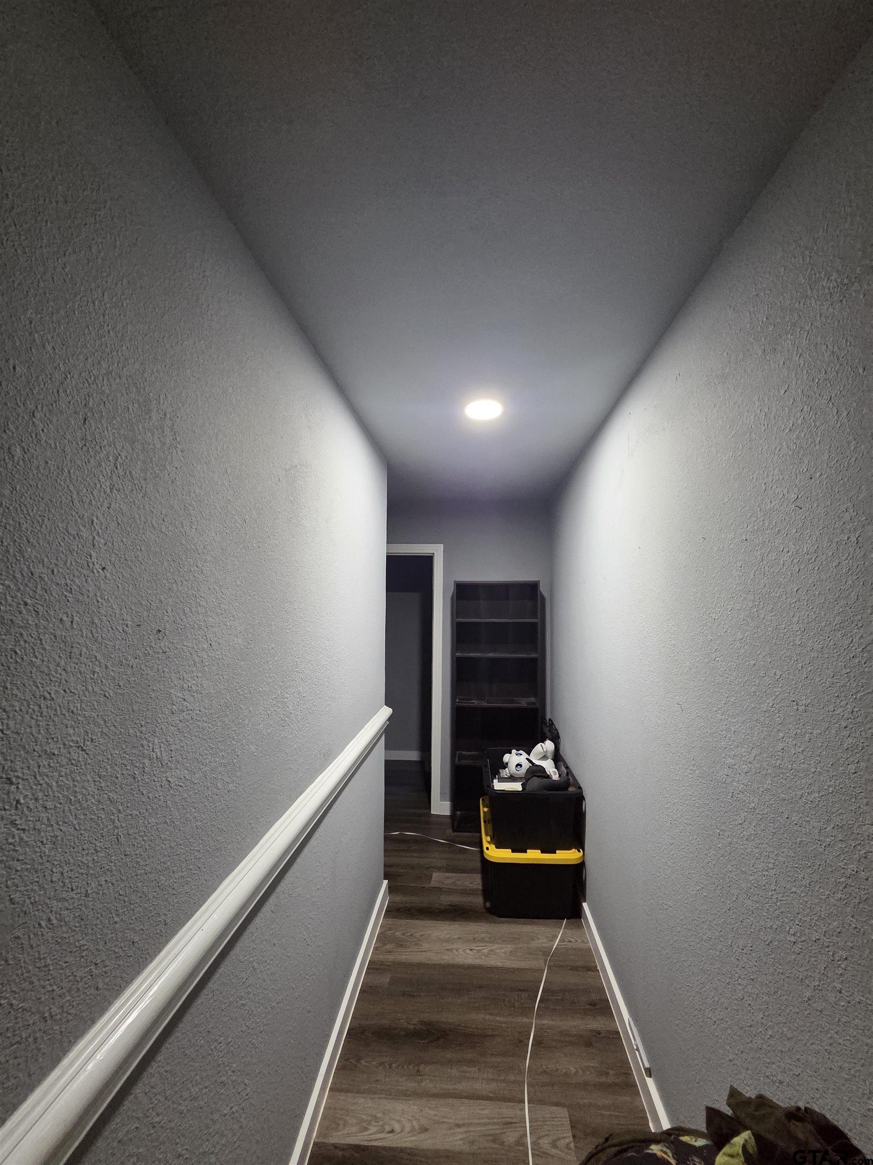 124 Foscue Street Sulphur Springs, TX 75482 - Photo 3 of 8 a room with wooden floor and gym equipment