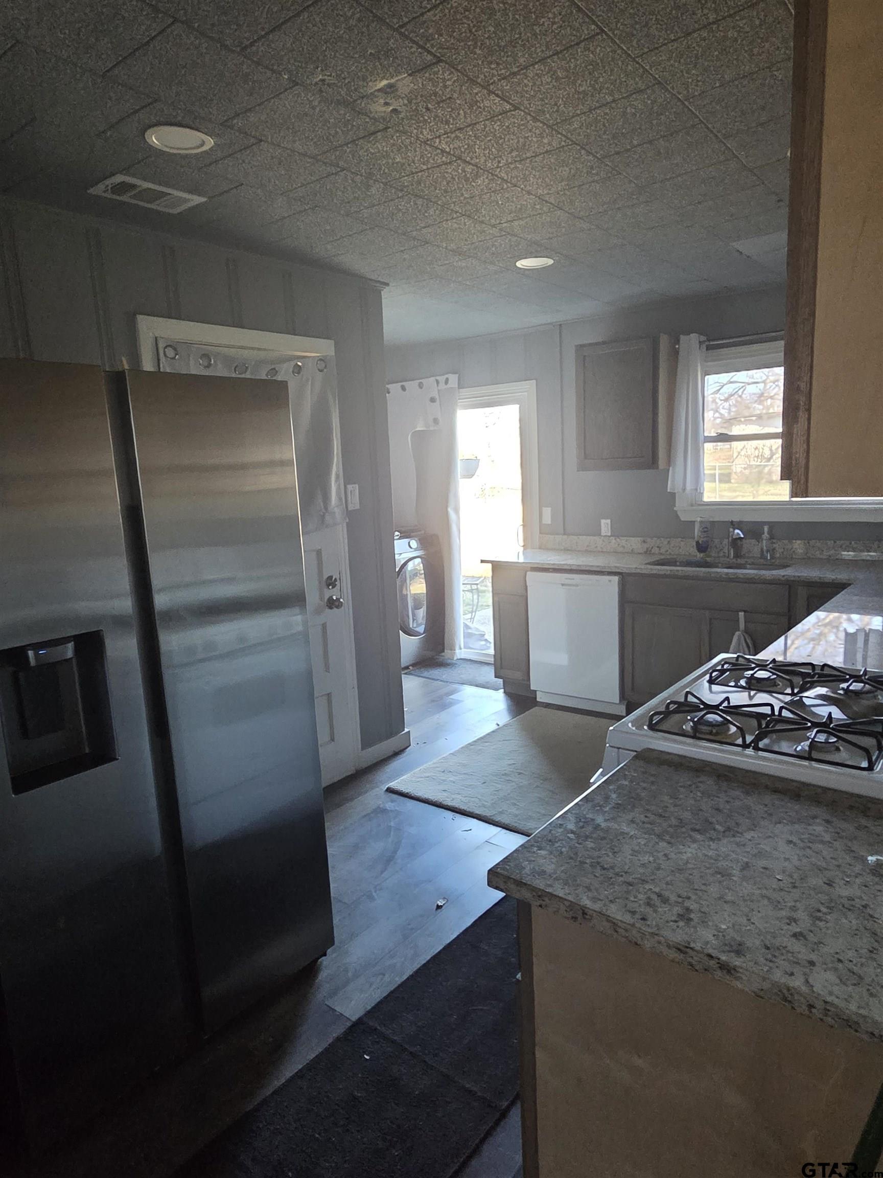 124 Foscue Street Sulphur Springs, TX 75482 - Photo 8 of 8 a kitchen with stainless steel appliances granite countertop a refrigerator and a sink