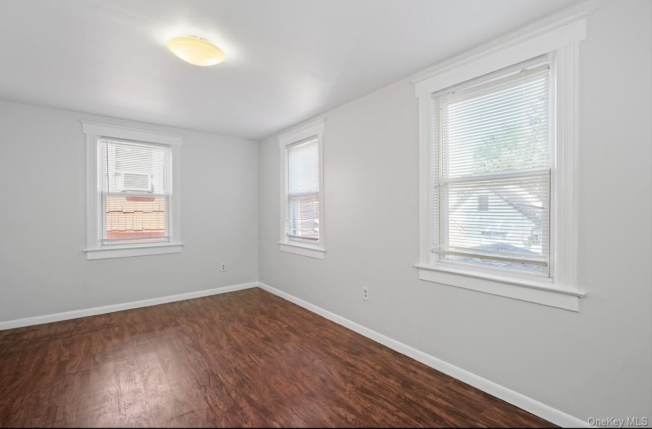 17 Edgar Place Port Chester, NY 10573 - Photo 11 of 18 Empty room with baseboards and dark wood-style flooring