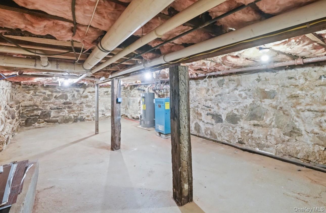 17 Edgar Place Port Chester, NY 10573 - Photo 18 of 18 Unfinished basement with water heater and a heating unit