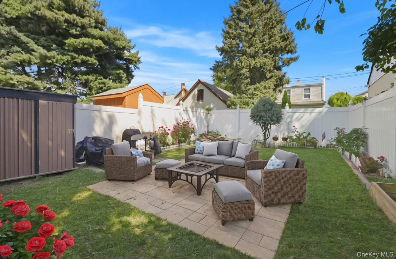17 Edgar Place Port Chester, NY 10573 - Photo 3 of 18 Fenced backyard with a patio area, outdoor lounge area, a storage shed, and grilling area