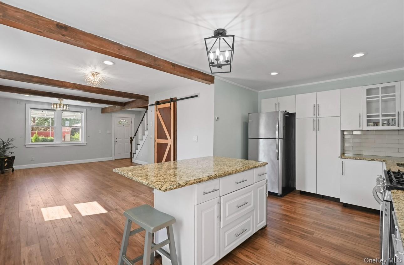 17 Edgar Place Port Chester, NY 10573 - Photo 4 of 18 Kitchen with white cabinets, a barn door, a chandelier, recessed lighting, and beamed ceiling