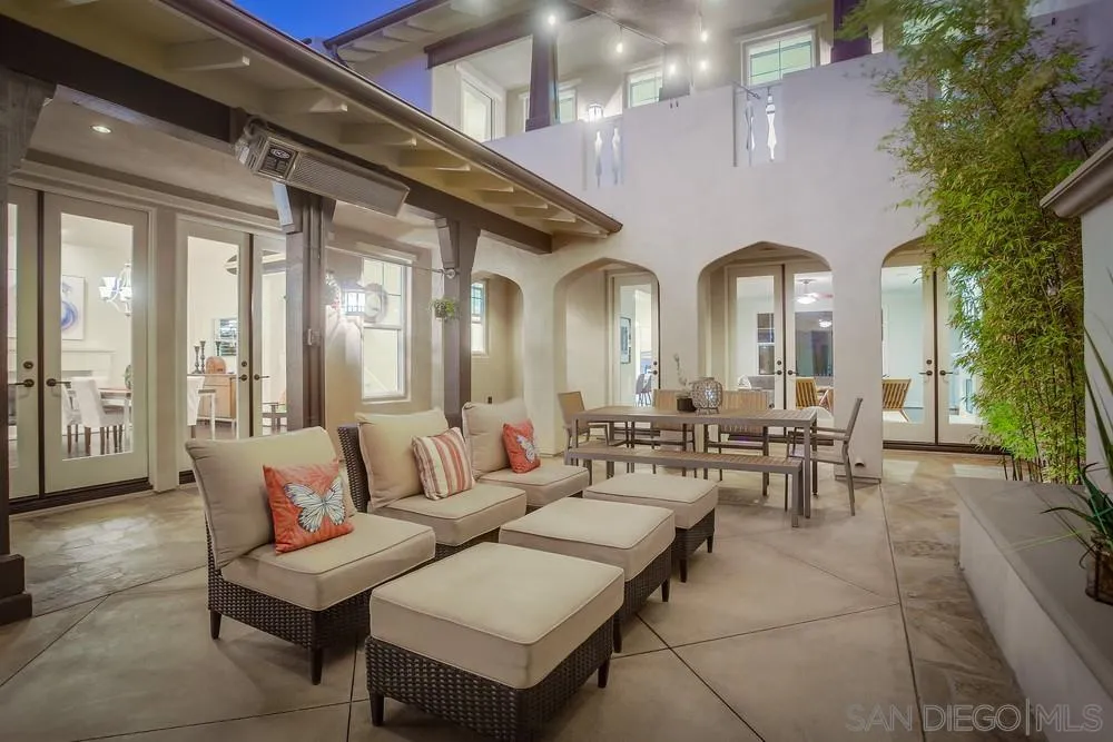 7535 Circulo Sequoia Carlsbad, CA 92009 - Photo 21 of 57 a view of a patio with couches table and chairs and potted plants