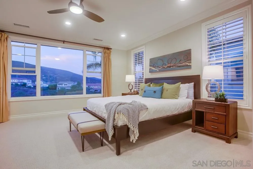 7535 Circulo Sequoia Carlsbad, CA 92009 - Photo 26 of 57 a bed sitting in a spacious bedroom next to a window