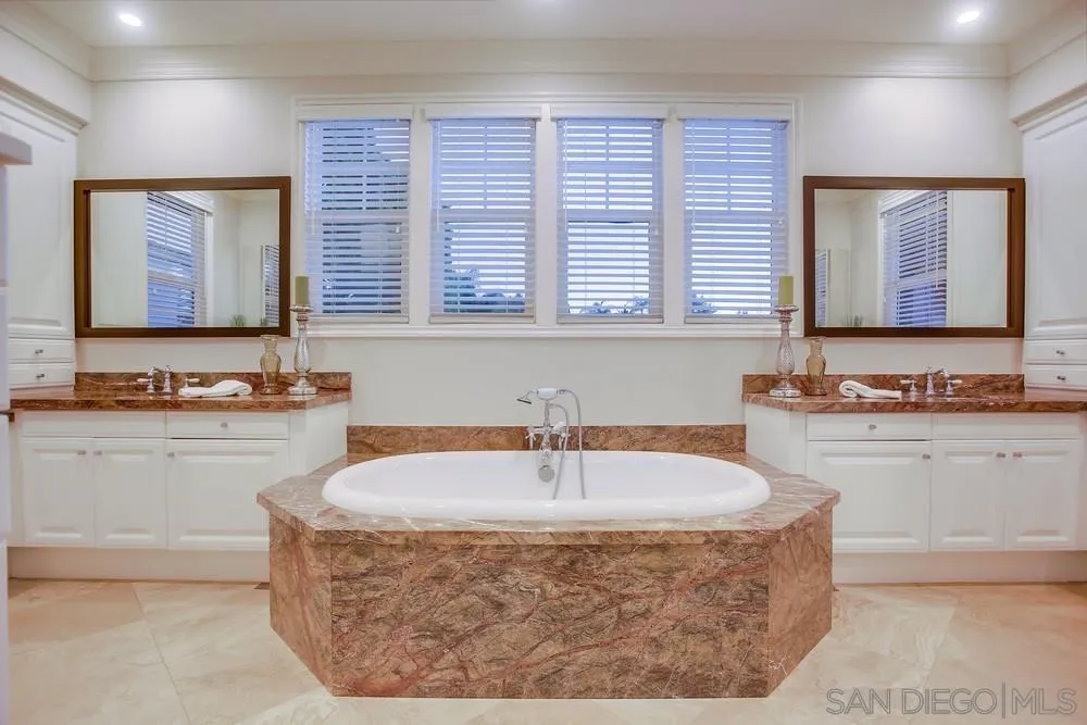7535 Circulo Sequoia Carlsbad, CA 92009 - Photo 29 of 57 a bathroom with a tub sink and mirror