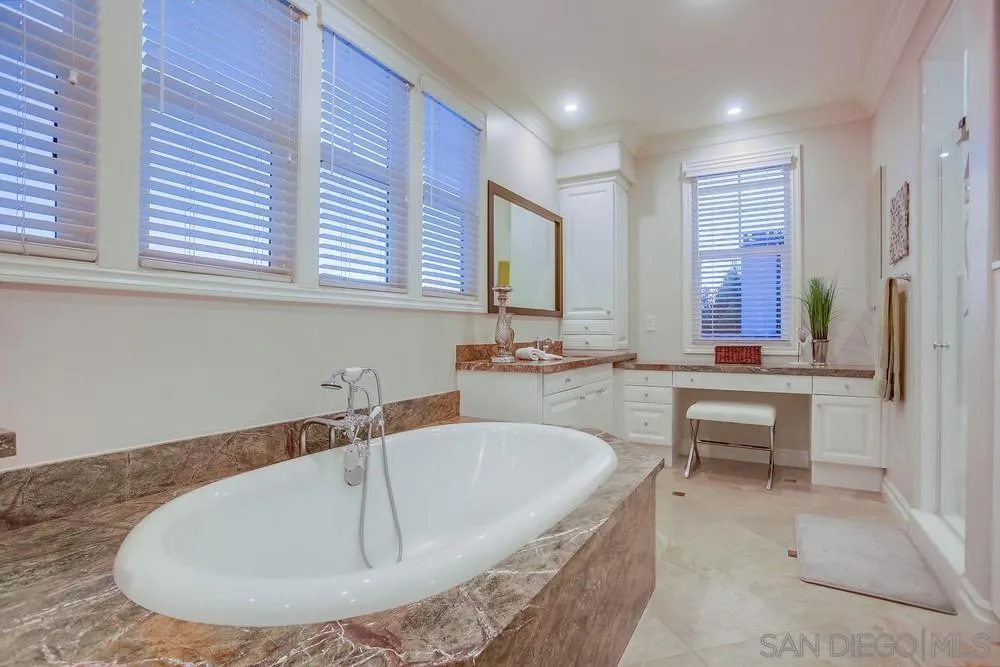7535 Circulo Sequoia Carlsbad, CA 92009 - Photo 30 of 57 a bathroom with a tub sink and mirror