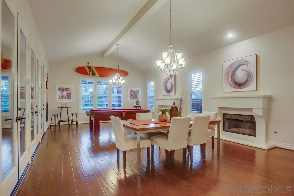 7535 Circulo Sequoia Carlsbad, CA 92009 - Photo 3 of 57 a dining room with furniture a fireplace and wooden floor