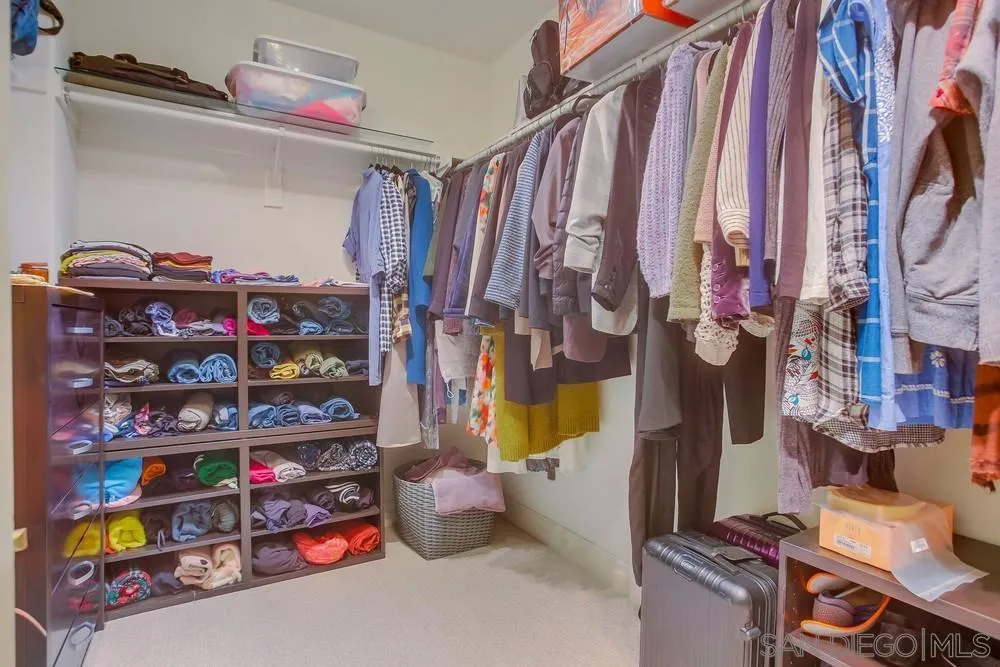 7535 Circulo Sequoia Carlsbad, CA 92009 - Photo 35 of 57 a view of walk in closet with clothes and shoes