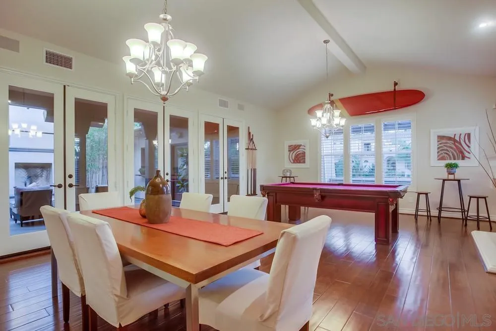 7535 Circulo Sequoia Carlsbad, CA 92009 - Photo 4 of 57 a dining room with wooden floor a chandelier a wooden table and chairs