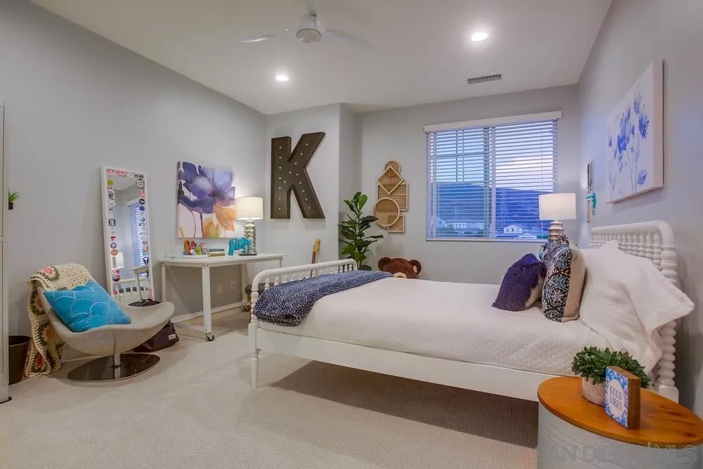 7535 Circulo Sequoia Carlsbad, CA 92009 - Photo 43 of 57 a bedroom with a bed window and couch
