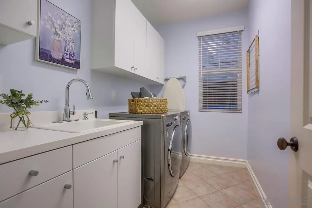 7535 Circulo Sequoia Carlsbad, CA 92009 - Photo 45 of 57 a utility room with cabinets washer and dryer