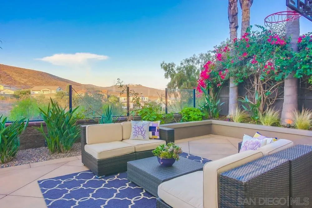 7535 Circulo Sequoia Carlsbad, CA 92009 - Photo 51 of 57 a view of a patio with couches table and chairs and potted plants