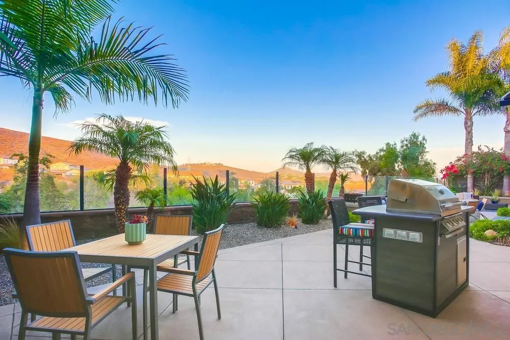 7535 Circulo Sequoia Carlsbad, CA 92009 - Photo 52 of 57 a patio with a table and chairs and potted plants