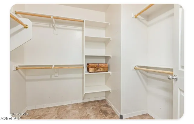 a view of walk in closet with empty racks