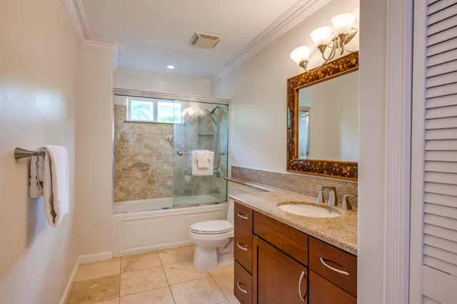 a bedroom with a bed and a potted plant