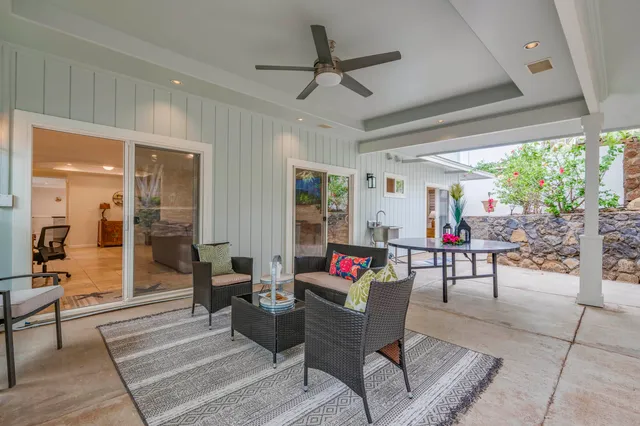 a kitchen with stainless steel appliances kitchen island granite countertop a table chairs and a refrigerator