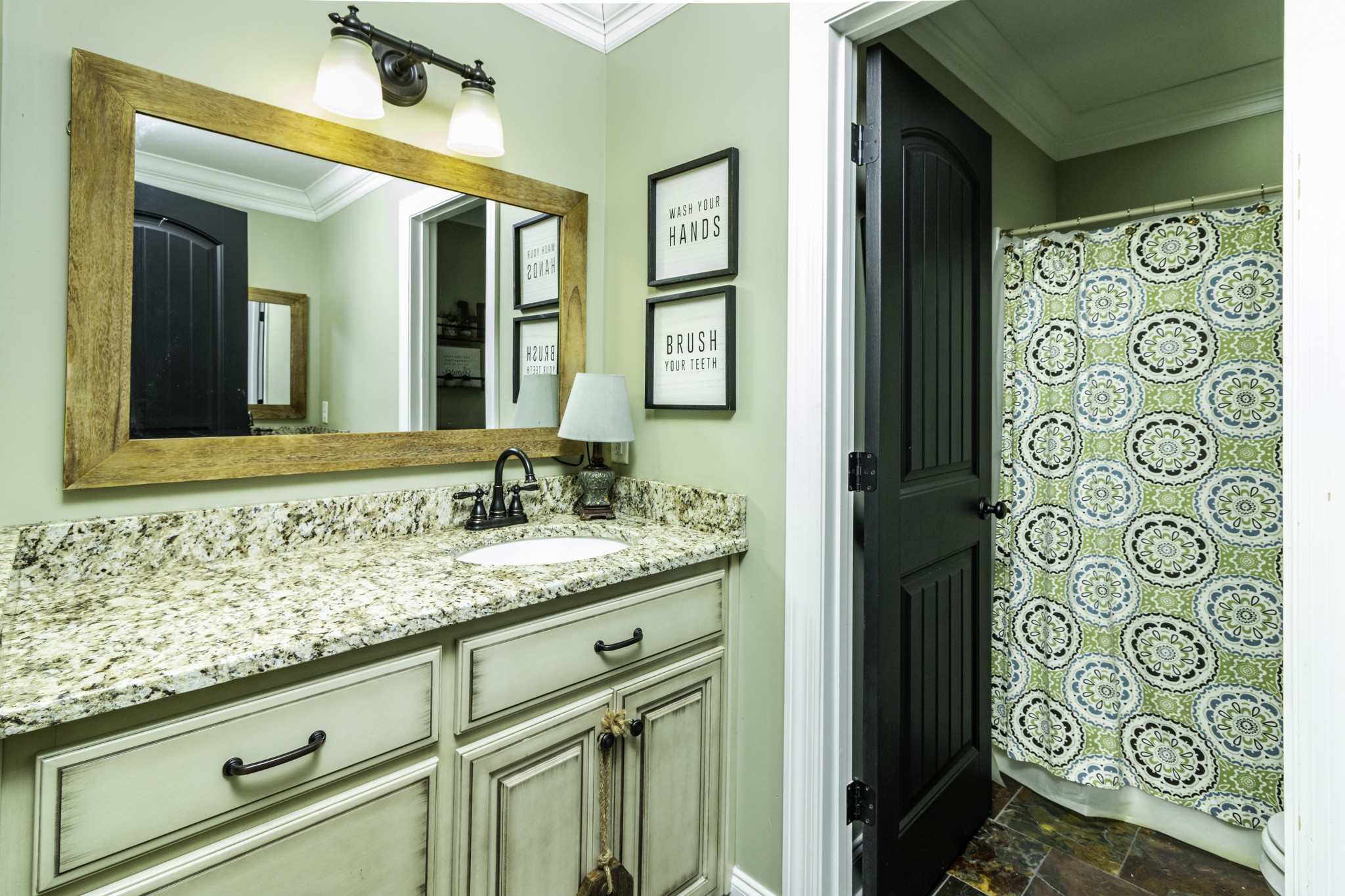 1705 Col James Hardin Road Clifton, TN 38425 - Photo 29 of 53 a bathroom with a granite countertop sink and a mirror