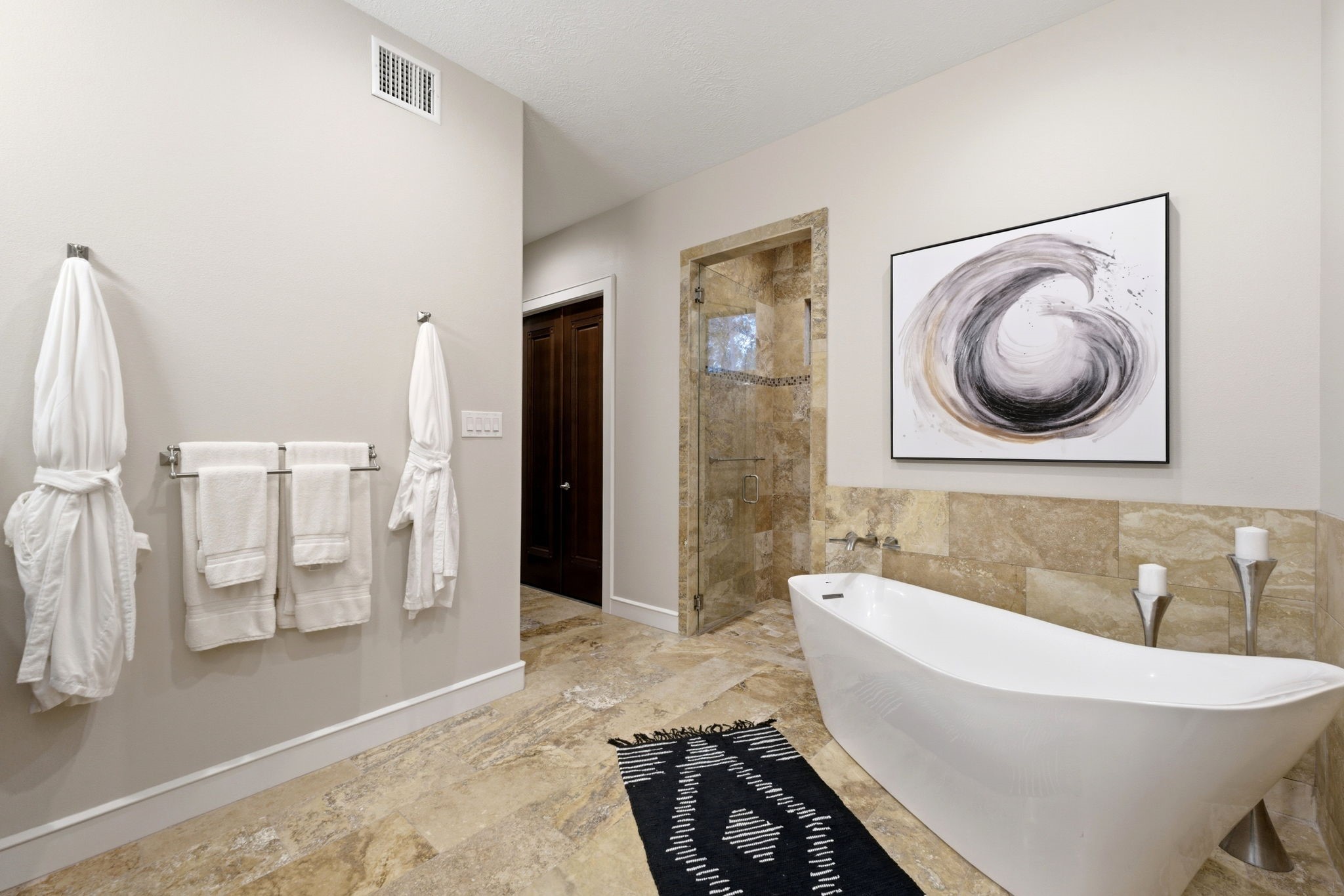 280 Sundog Road Huntsville, TX 77340 - Photo 25 of 50 Another view of the primary bathroom highlighting the freestanding soaking tub, entrance to the walk-in shower, and access to one of the two walk-in closets with built-ins.