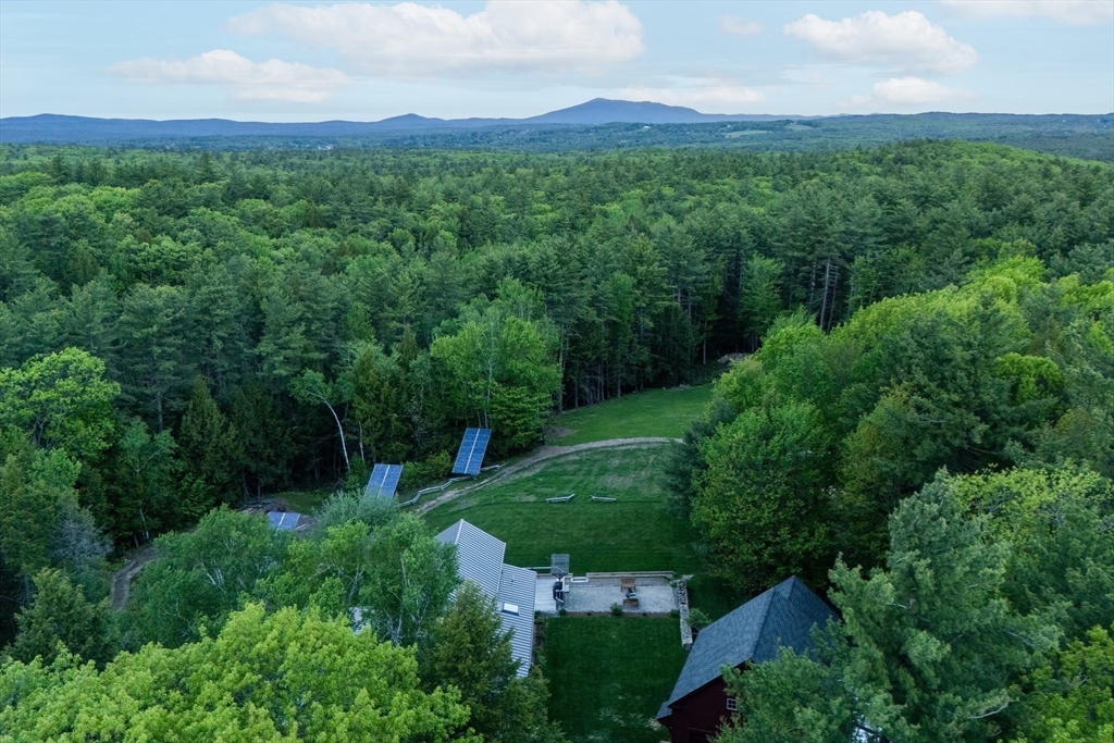 360 Teel Road Winchendon, MA 01475 - Photo 36 of 42 an aerial view of green landscape with trees houses and mountain view