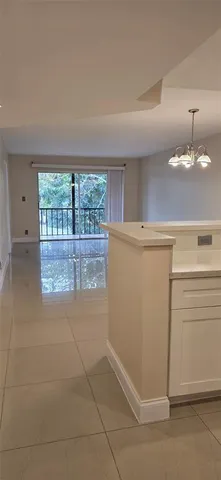 a view of a kitchen with an empty space and window