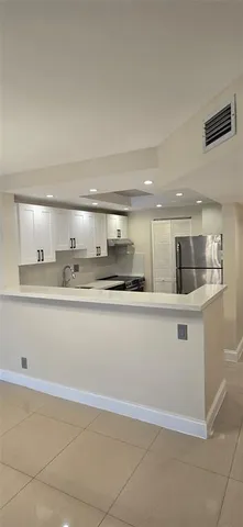 a view with kitchen island sink and natural light