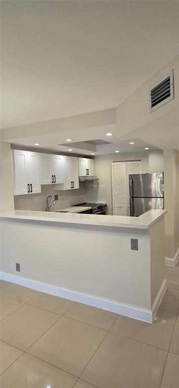 8000 South Colony Circle, Unit 309 Tamarac, FL 33321 - Photo 3 of 19 a view with kitchen island sink and natural light