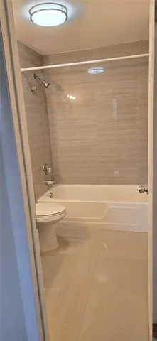 a bathroom with a shower and a sink