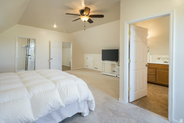 684 Blue Mountain Ridge Monticello, UT 84535 - Photo 50 of 71 Bedroom featuring ensuite bath, light colored carpet, vaulted ceiling, ceiling fan, and light tile patterned floors