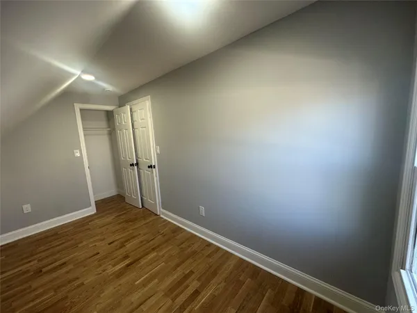 an empty room with wooden floor