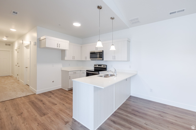 693 West 4500th South, Unit O301 Mapleton, UT 84664 - Photo 12 of 16 Kitchen with stainless steel appliances, a peninsula, pendant lighting, and light wood-type flooring