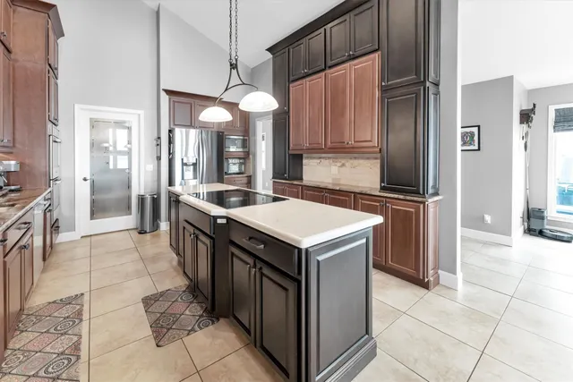a kitchen that has a table and a chandelier
