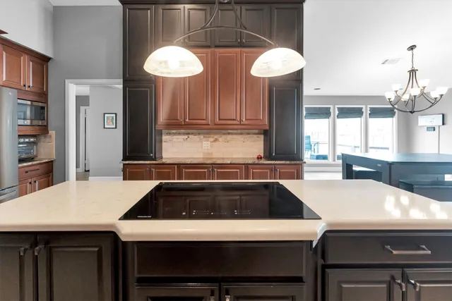 a kitchen with a stove a sink and a refrigerator